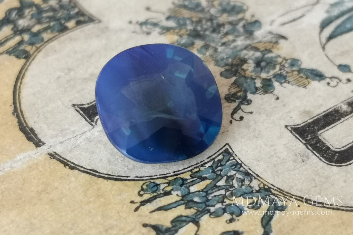Untreated greenish blue Sapphire 3.61 ct. Cushion cut.  natural untreated blue sapphire has a large green component inside, under natural light you can see a dull and translucent blue sapphire, although under incandescent light everything changes, this sapphire shines from all sides and a bright green color is seen throughout the interior. It is a gem only for the very daring, with an extra: its price (certificate included).