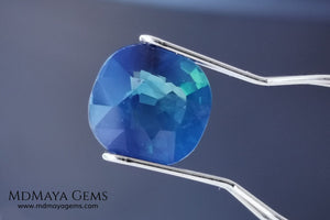Untreated greenish blue Sapphire 3.61 ct. Cushion cut.  natural untreated blue sapphire has a large green component inside, under natural light you can see a dull and translucent blue sapphire, although under incandescent light everything changes, this sapphire shines from all sides and a bright green color is seen throughout the interior. It is a gem only for the very daring, with an extra: its price (certificate included).