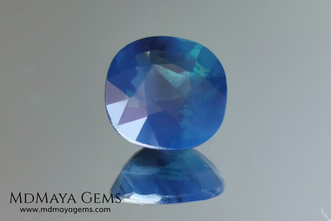 Untreated greenish blue Sapphire 3.61 ct. Cushion cut.  natural untreated blue sapphire has a large green component inside, under natural light you can see a dull and translucent blue sapphire, although under incandescent light everything changes, this sapphire shines from all sides and a bright green color is seen throughout the interior. It is a gem only for the very daring, with an extra: its price (certificate included).