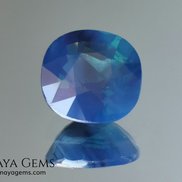 Untreated greenish blue Sapphire 3.61 ct. Cushion cut.  natural untreated blue sapphire has a large green component inside, under natural light you can see a dull and translucent blue sapphire, although under incandescent light everything changes, this sapphire shines from all sides and a bright green color is seen throughout the interior. It is a gem only for the very daring, with an extra: its price (certificate included).