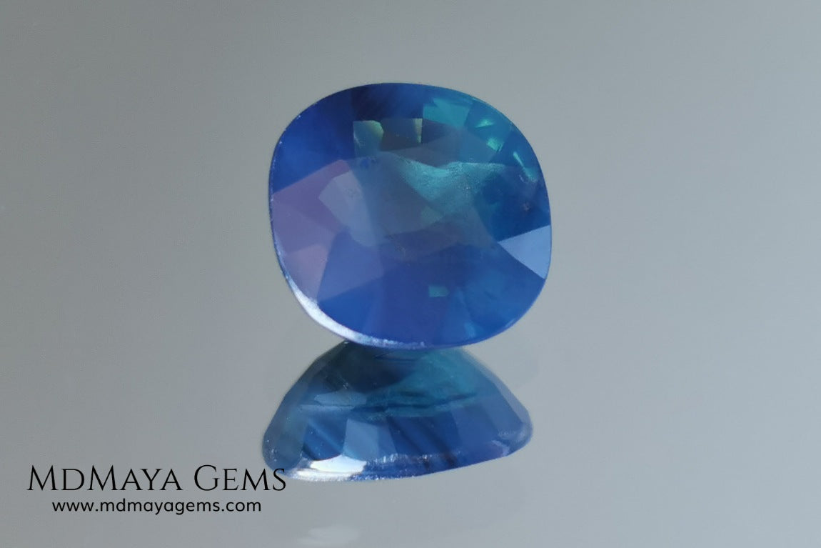 Untreated greenish blue Sapphire 3.61 ct. Cushion cut.  natural untreated blue sapphire has a large green component inside, under natural light you can see a dull and translucent blue sapphire, although under incandescent light everything changes, this sapphire shines from all sides and a bright green color is seen throughout the interior. It is a gem only for the very daring, with an extra: its price (certificate included).
