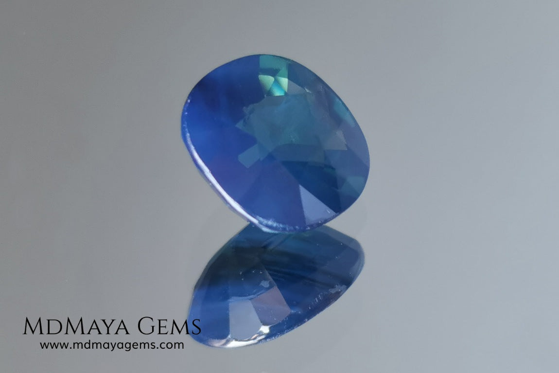 Untreated greenish blue Sapphire 3.61 ct. Cushion cut.  natural untreated blue sapphire has a large green component inside, under natural light you can see a dull and translucent blue sapphire, although under incandescent light everything changes, this sapphire shines from all sides and a bright green color is seen throughout the interior. It is a gem only for the very daring, with an extra: its price (certificate included).