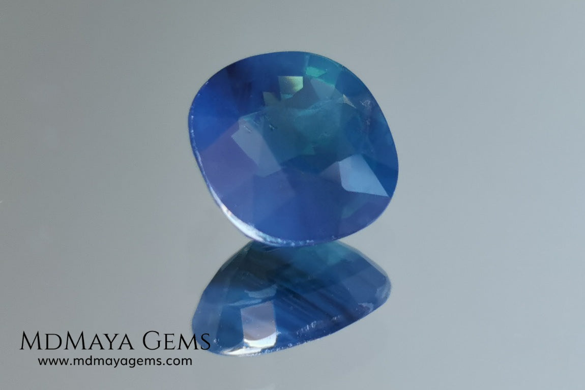Untreated greenish blue Sapphire 3.61 ct. Cushion cut.  natural untreated blue sapphire has a large green component inside, under natural light you can see a dull and translucent blue sapphire, although under incandescent light everything changes, this sapphire shines from all sides and a bright green color is seen throughout the interior. It is a gem only for the very daring, with an extra: its price (certificate included).