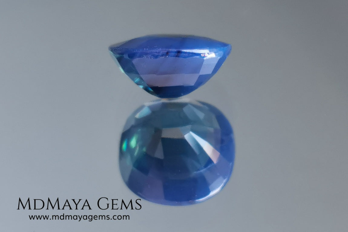 Untreated greenish blue Sapphire 3.61 ct. Cushion cut.  natural untreated blue sapphire has a large green component inside, under natural light you can see a dull and translucent blue sapphire, although under incandescent light everything changes, this sapphire shines from all sides and a bright green color is seen throughout the interior. It is a gem only for the very daring, with an extra: its price (certificate included).