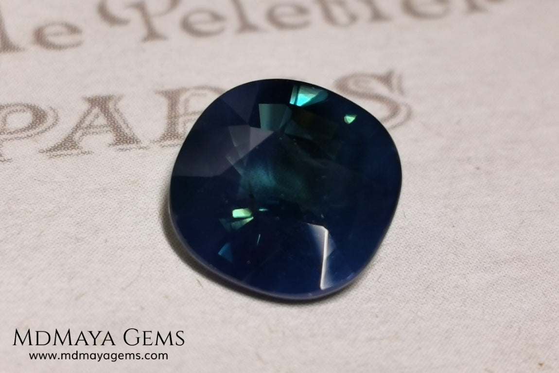 Untreated greenish blue Sapphire 3.61 ct. Cushion cut.  natural untreated blue sapphire has a large green component inside, under natural light you can see a dull and translucent blue sapphire, although under incandescent light everything changes, this sapphire shines from all sides and a bright green color is seen throughout the interior. It is a gem only for the very daring, with an extra: its price (certificate included).
