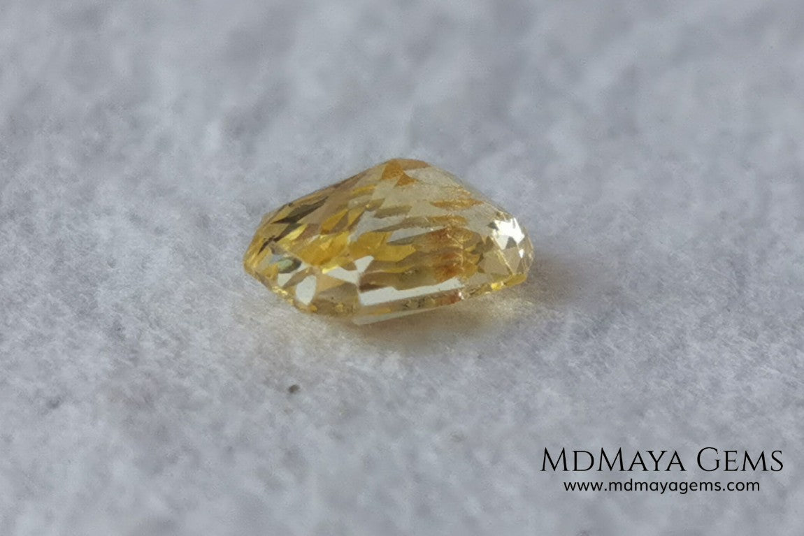  Vivid Yellow Sapphire. Radiant Cut. 0.89 ct. This small precious stone is full of life and color, its bright yellow is superb, has a nick in the crown, (this is the reason of its low price), but is an incredible gemstone that will look impressive in any ring or any piece of jewelry.