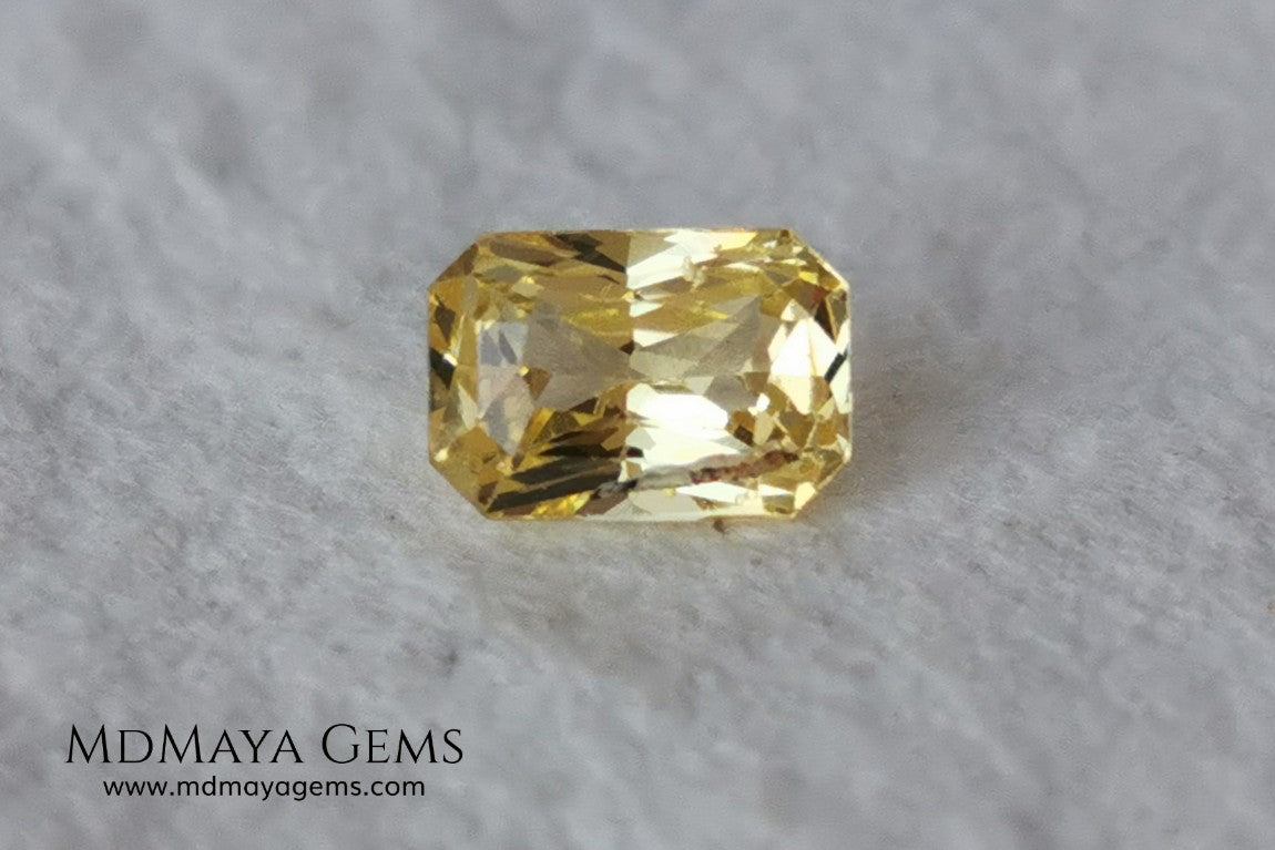  Vivid Yellow Sapphire. Radiant Cut. 0.89 ct. This small precious stone is full of life and color, its bright yellow is superb, has a nick in the crown, (this is the reason of its low price), but is an incredible gemstone that will look impressive in any ring or any piece of jewelry.