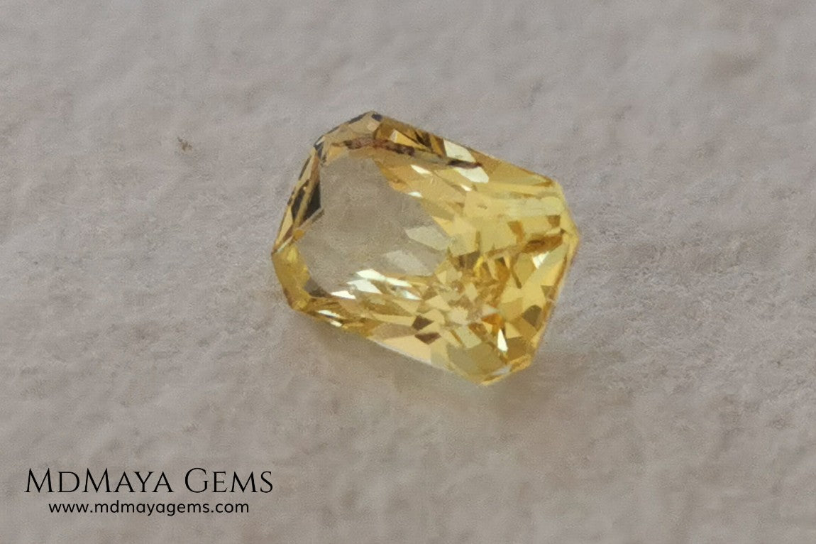  Vivid Yellow Sapphire. Radiant Cut. 0.89 ct. This small precious stone is full of life and color, its bright yellow is superb, has a nick in the crown, (this is the reason of its low price), but is an incredible gemstone that will look impressive in any ring or any piece of jewelry.