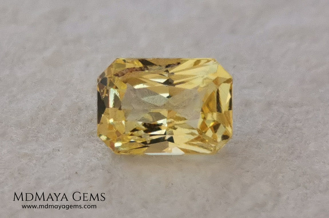  Vivid Yellow Sapphire. Radiant Cut. 0.89 ct. This small precious stone is full of life and color, its bright yellow is superb, has a nick in the crown, (this is the reason of its low price), but is an incredible gemstone that will look impressive in any ring or any piece of jewelry.